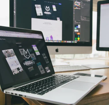 Website design and UI development displayed on laptop and desktop screens