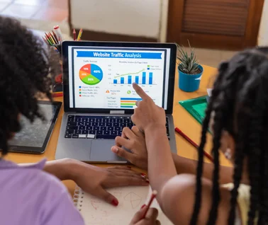 Students reviewing website traffic analytics for digital education platform